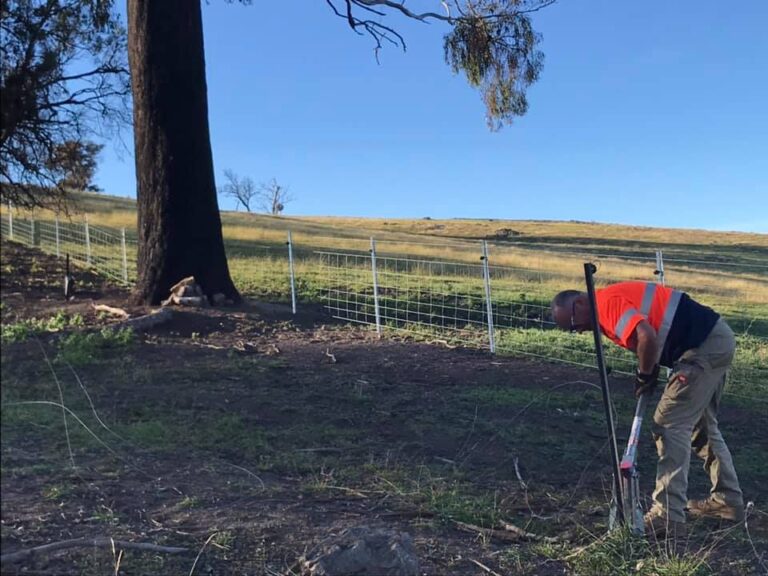 Blazeaid volunteer repairing fencing