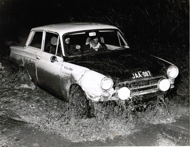 a Mk1 Cortina crossing a ford in a rally