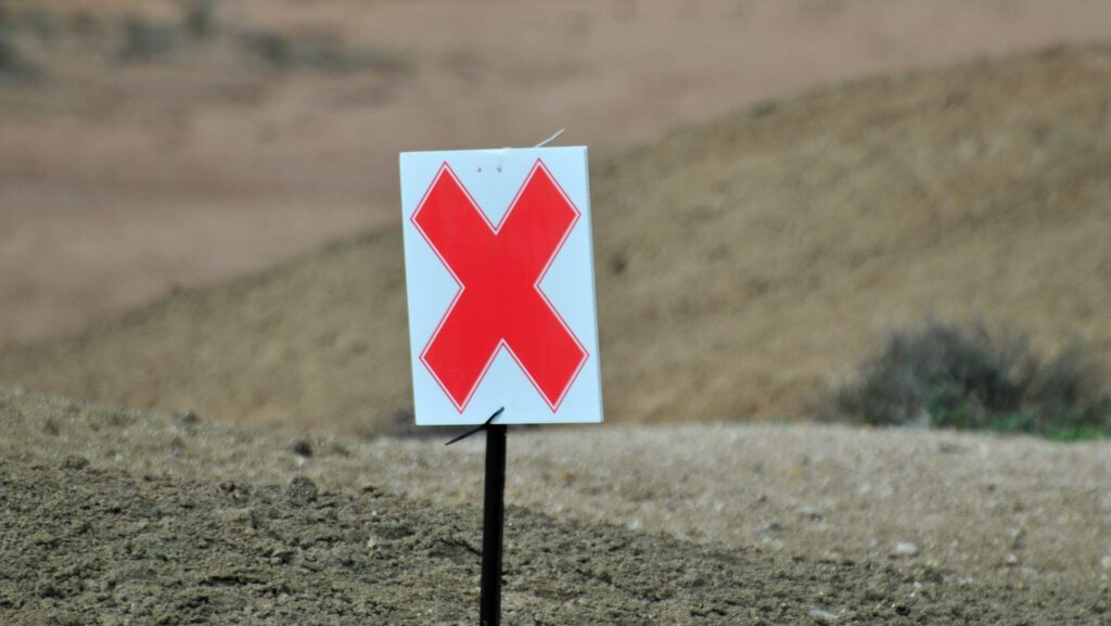 X Board on the side of a track
